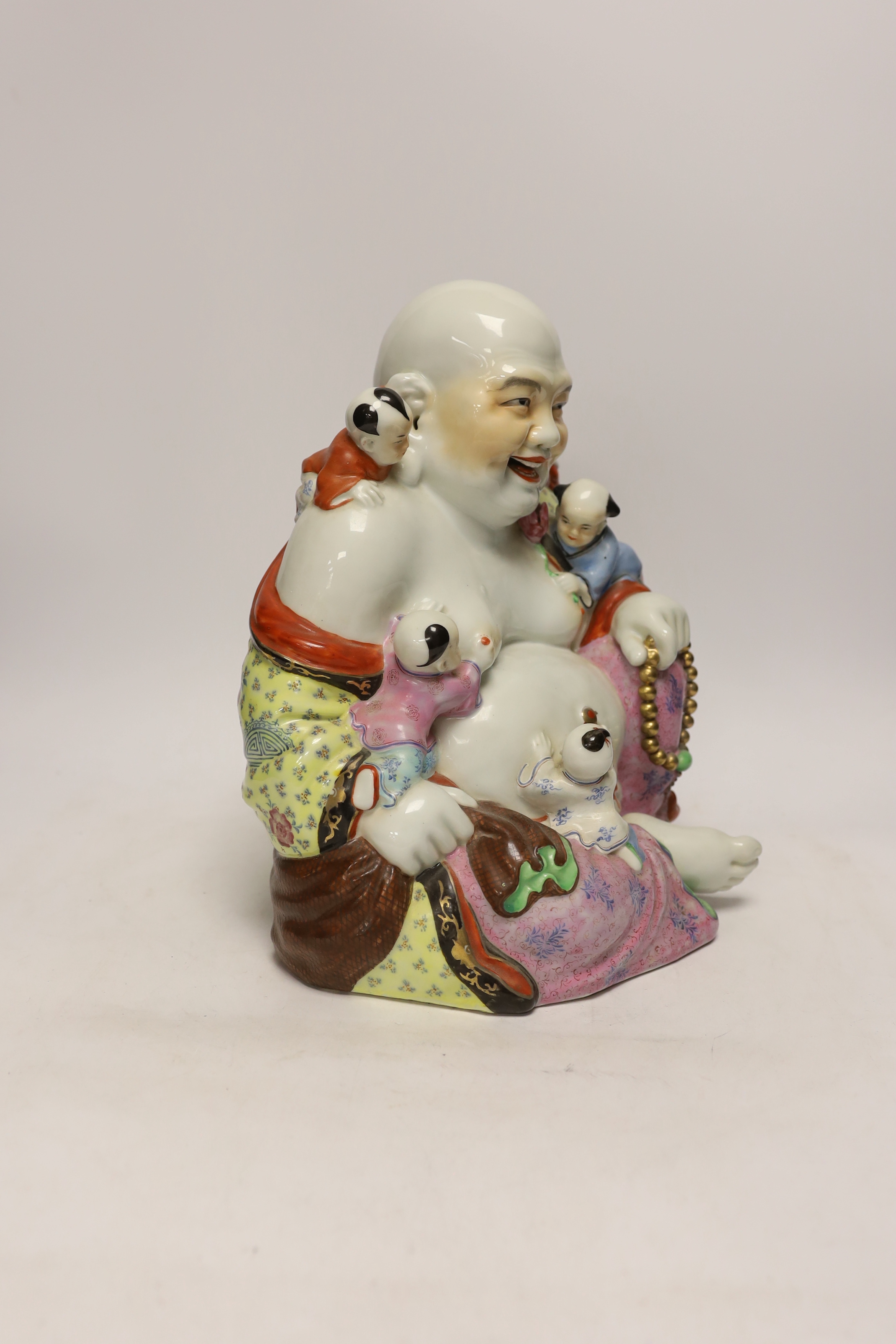 A Chinese enamelled porcelain group of laughing Budai with children, mid 20th century, 31cm high